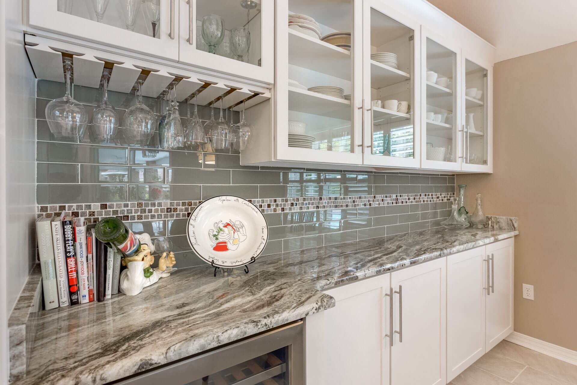 Custom Shaker cabinets with glass panels, granite countertops, and glass tile backsplash