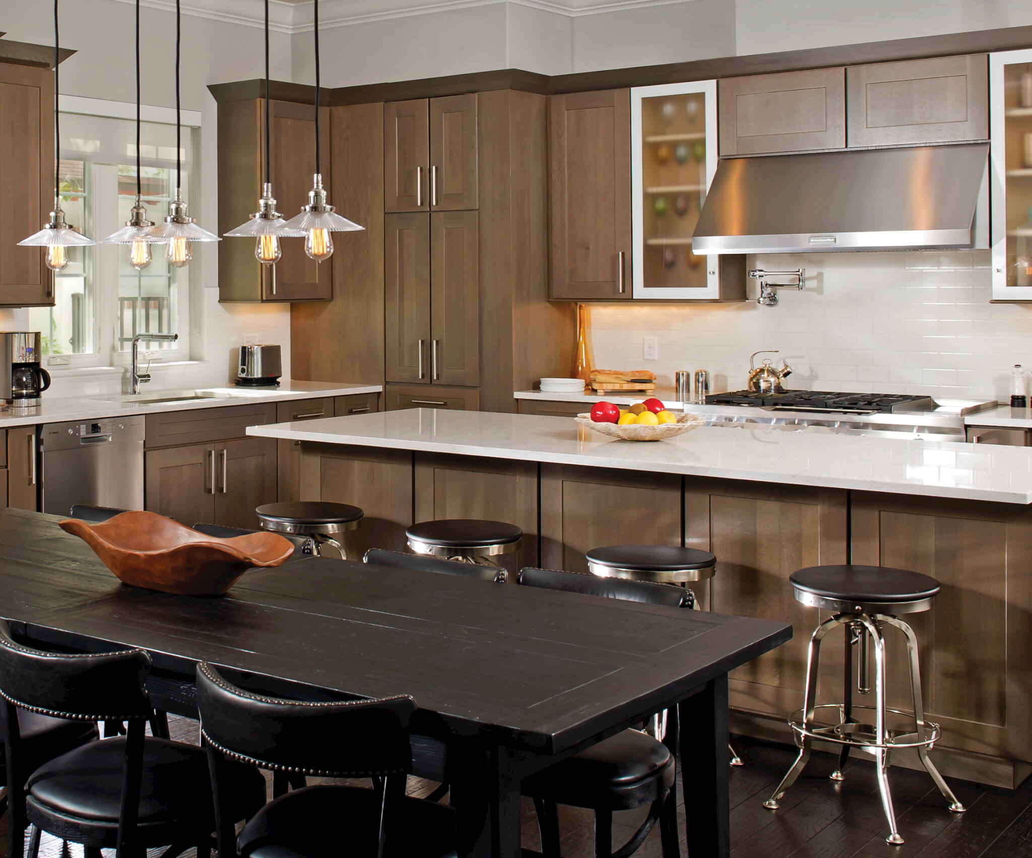 A kitchen with warm brown woods featuring Kabinart custom cabinets