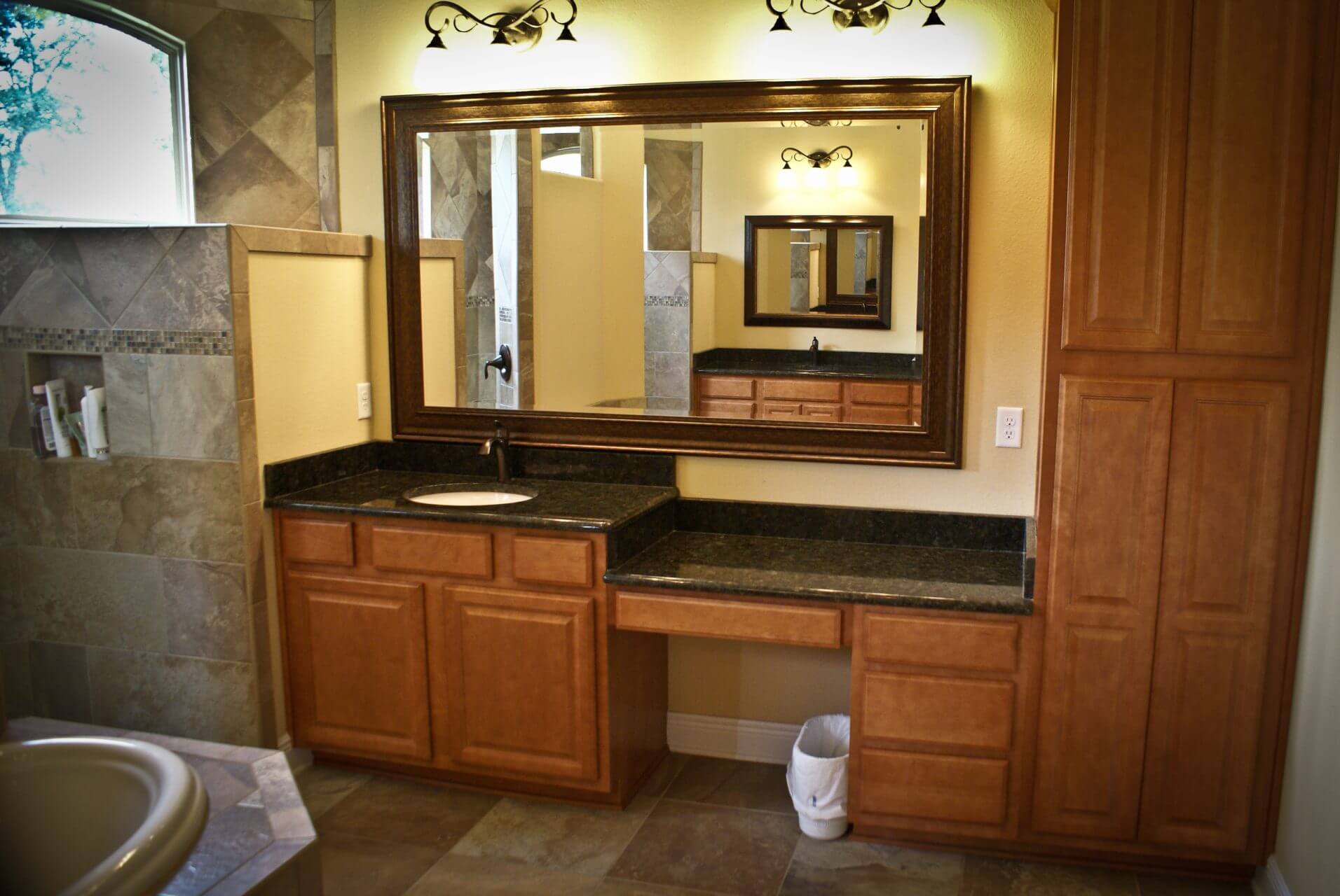 Master bathroom sink and vanity with granite countertops and modern wood cabinets