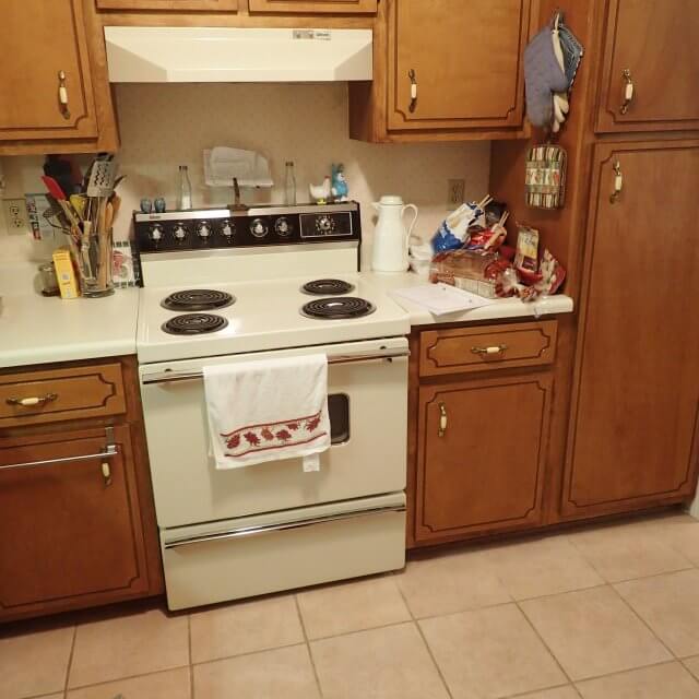 Old kitchen with outdated stove and hood
