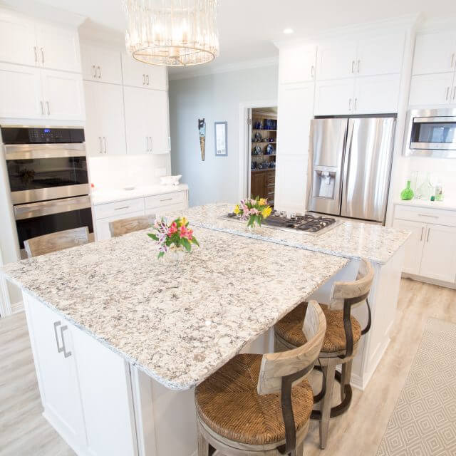 Quartz countertops with white Shaker cabinets and modern hardware