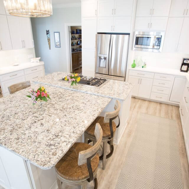 Custom designed kitchen cabinets with quartz countertops and stainless steel appliances