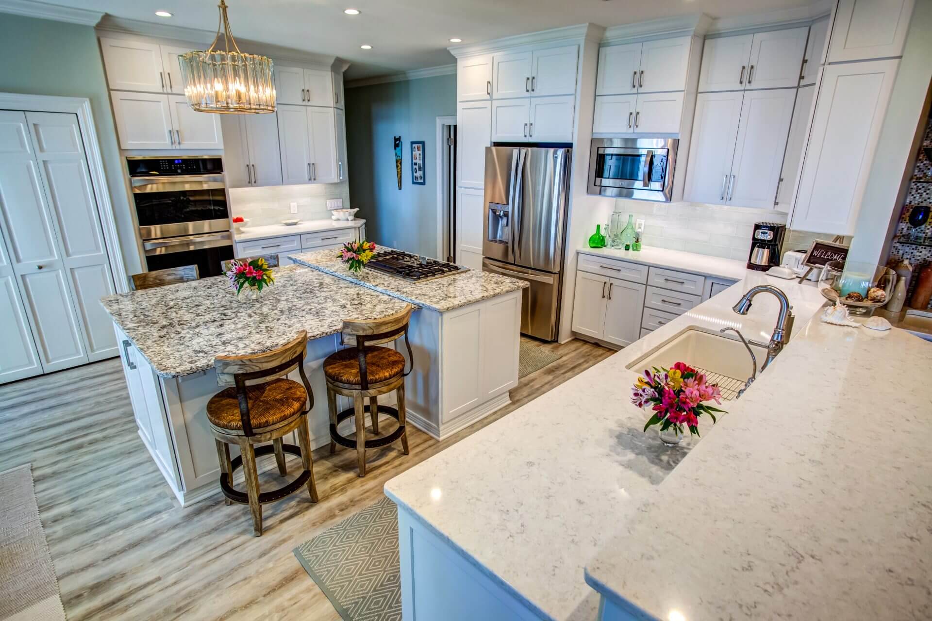 Sleek modern kitchen with stacked Shaker cabinets, quartz countertops and glass subway tile backsplash