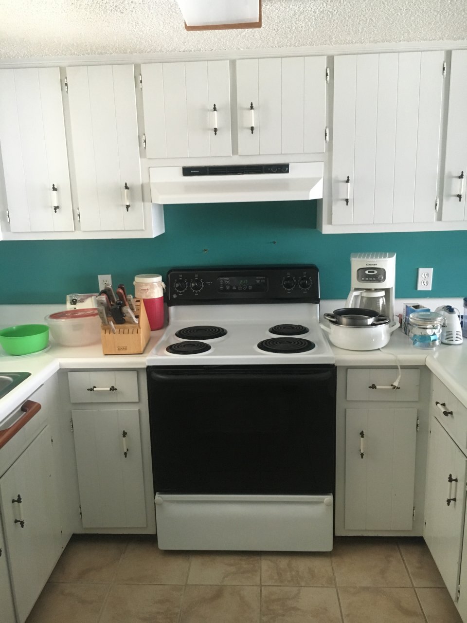 Before picture of beach house kitchen old cabinets and appliances