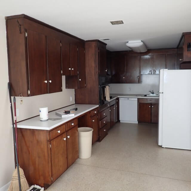 Before: Old dark brown cabinets in kitchen remodel and linoleum floor
