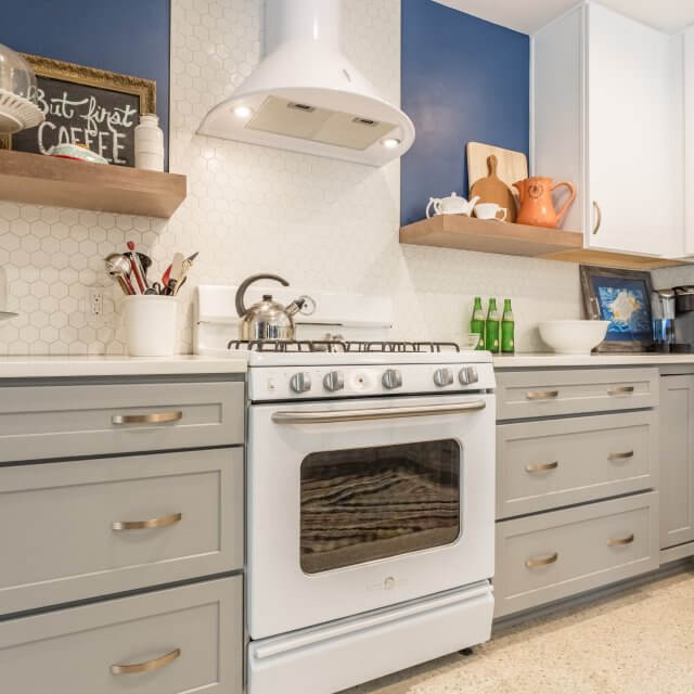 After: Mid-century modern kitchen remodel with grayish drawers that add a pop of color