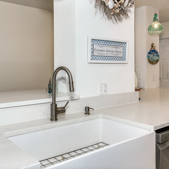 Contemporary farmhouse sink in condo kitchen remodel